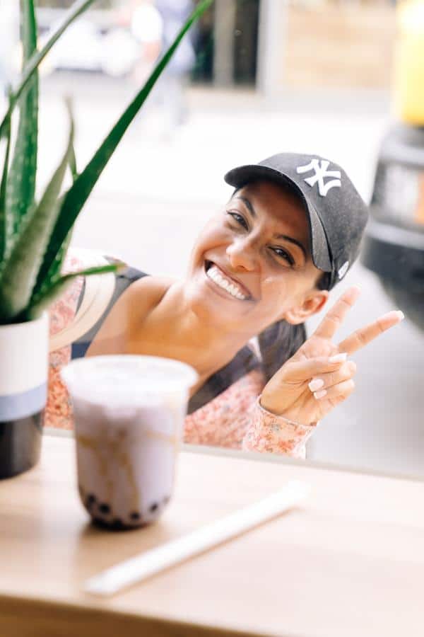 woman smiling behind the cold coffee