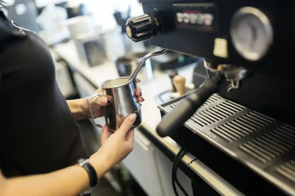 Barista preparing coffee with coffee machine