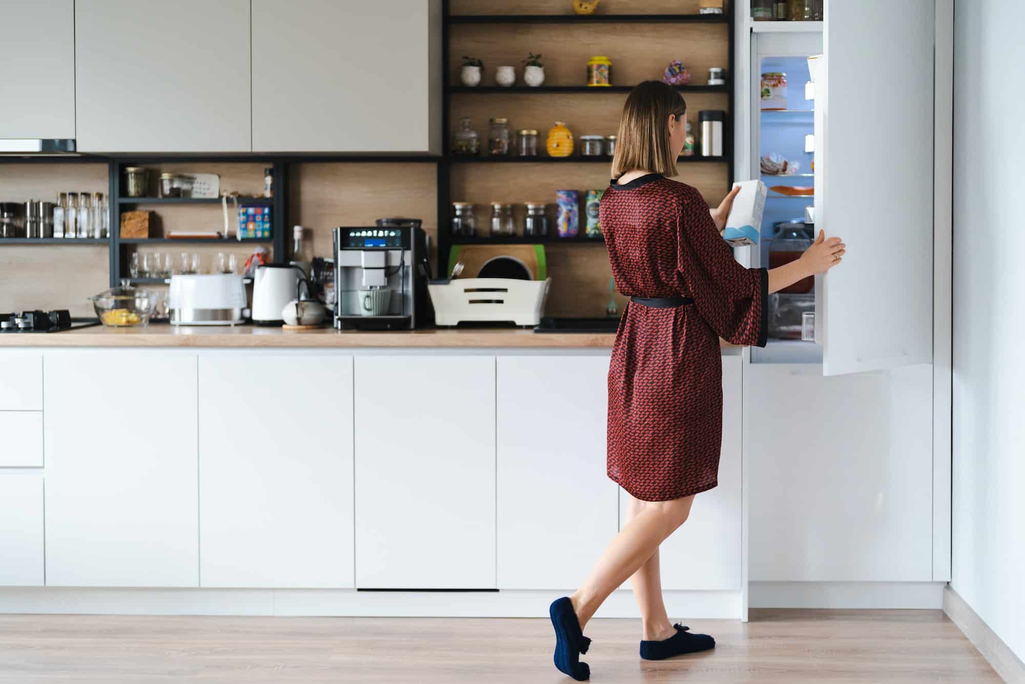 Hungry Woman Looking For Food In the Fridge Kitchen At Home