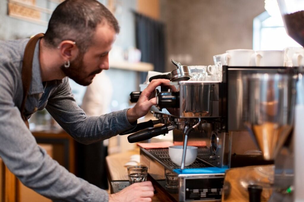 Barista preparing coffee with coffee machine