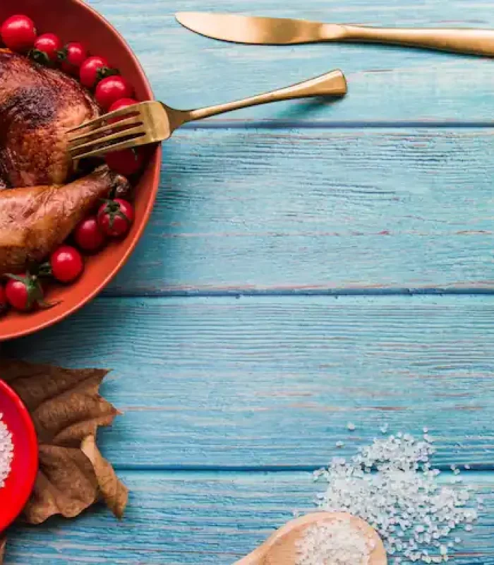 delicious-roasted-chicken-dinner-with-beer-salt-sauce-corn-cherry-tomatoes-table_23-2148029618
